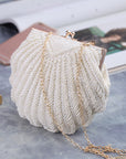 a Handcrafted Bead Embroidery Evening Bag with a Shell-Inspired Design, a stunning and unique accessory perfect for formal events and special occasions.