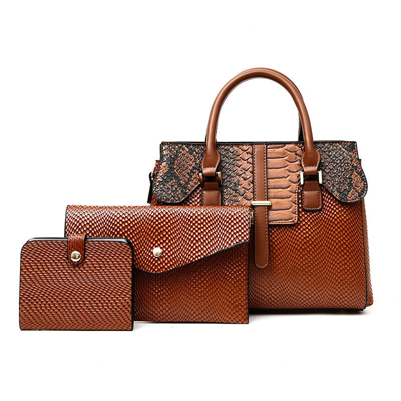 Premium brown leather handbag set featuring a spacious handbag with snake-embossed details, an envelope-style clutch, and a compact wallet, all designed with textured finishes and metallic accents, displayed against a clean white background.