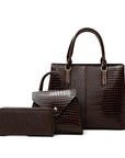 Three-piece brown crocodile-textured faux leather bag set featuring a spacious tote bag with sturdy handles, a compact mini handbag with a stylish flap closure, and a matching wallet. The set exudes elegance with its bold red color and sophisticated crocodile pattern, perfect for various occasions.