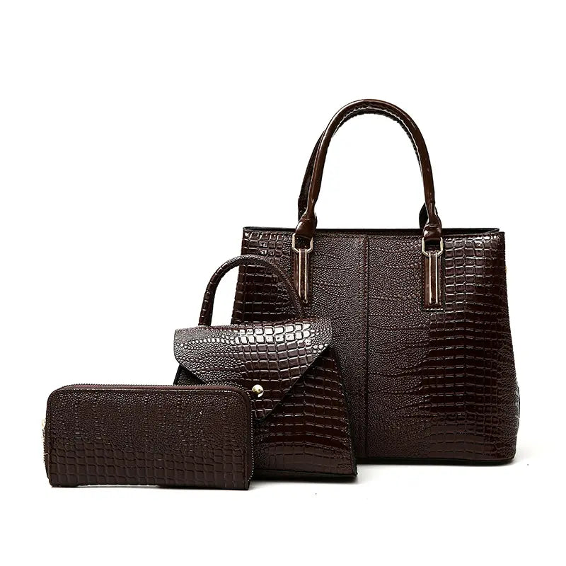 Three-piece brown crocodile-textured faux leather bag set featuring a spacious tote bag with sturdy handles, a compact mini handbag with a stylish flap closure, and a matching wallet. The set exudes elegance with its bold red color and sophisticated crocodile pattern, perfect for various occasions.