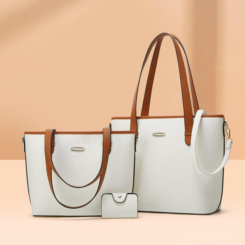 Three-piece leather bag set featuring a dual-tone design with a white body and camel-brown accents, including a large tote bag, a medium shoulder bag, and a compact wallet. The set offers a sophisticated and versatile style for everyday use.