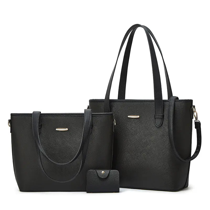 Three-piece leather bag set featuring a dual-tone design with black, including a large tote bag, a medium shoulder bag, and a compact wallet. The set offers a sophisticated and versatile style for everyday use.