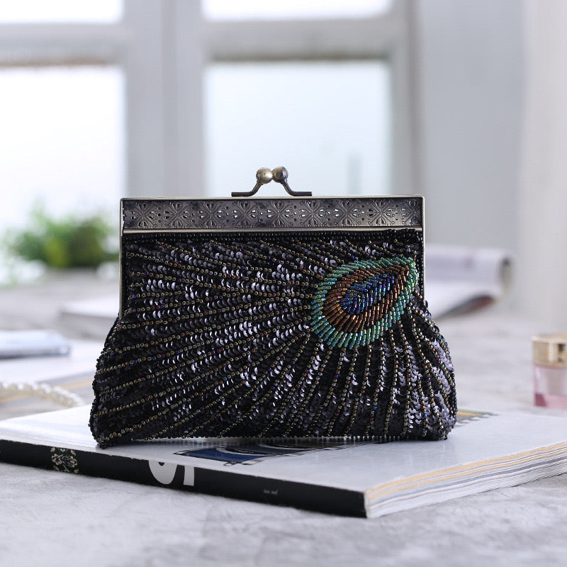 This is a vintage handbag with intricate bead embroidery, designed for crossbody or handheld use. Inspired by traditional qipao dresses, it complements evening attire beautifully. The bag features exquisite bead embroidery, showcasing the craftsmanship of Chinese heritage. Whether worn with a qipao or for any formal occasion, this handbag is the perfect accessory.