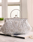 This is an image of a silver clutch purse. The clutch features a sleek and shiny silver exterior with a delicate chain strap. It is a stylish accessory, perfect for adding a touch of sophistication to any evening outfit.