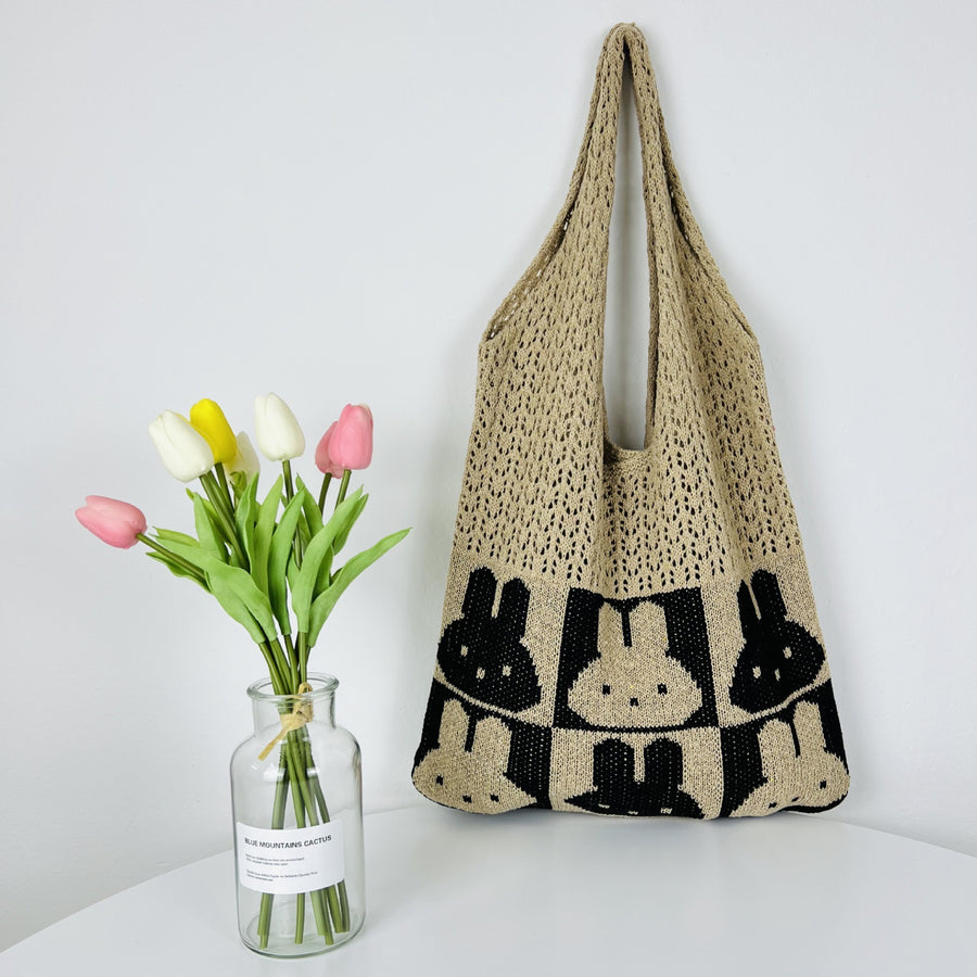 Colorful crochet shoulder bag with a playful pattern and tassel detail.