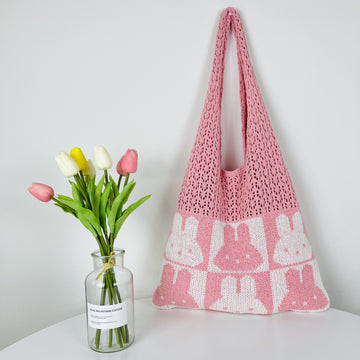 Colorful crochet shoulder bag with a playful pattern and tassel detail.