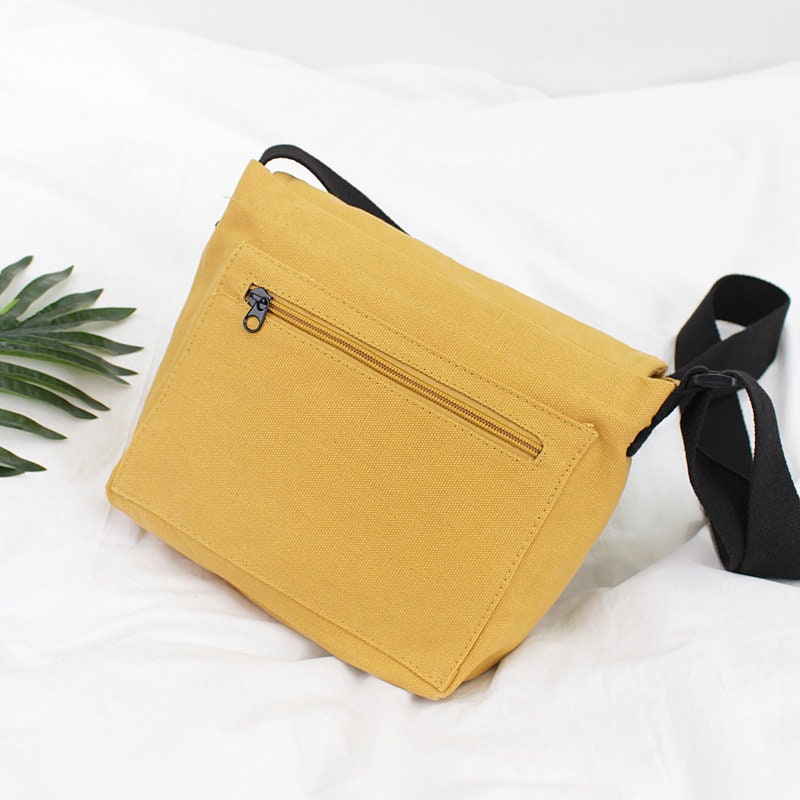 Travel in Style with Our Spacious and Lightweight Canvas Crossbody Bag