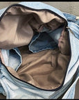 Durable denim satchel with multiple pockets for organization