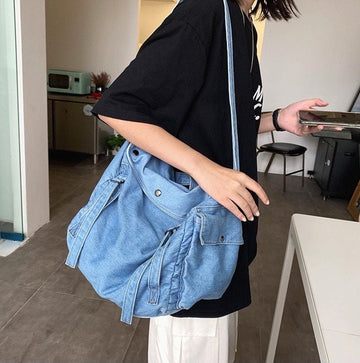 Stylish denim messenger bag with adjustable shoulder strap and flap closure