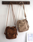 Versatile canvas shoulder bag with roomy main compartment and multiple pockets